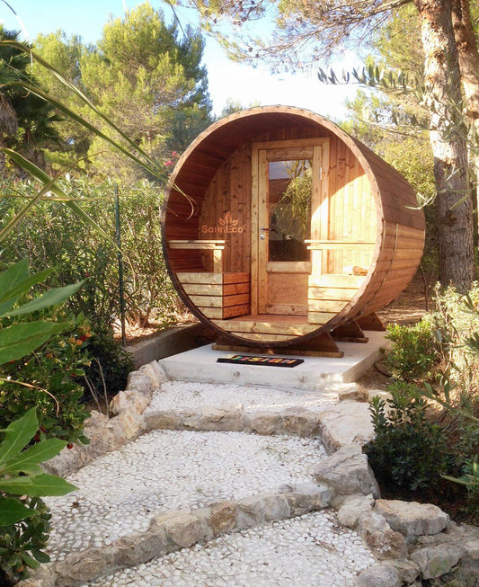 Compact barrel sauna interior with log-fired stove